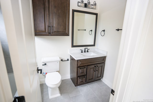 bathroom featuring tile patterned flooring, vanity, and toilet