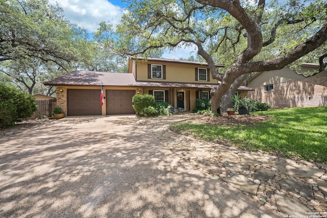 view of property with a front lawn and a garage