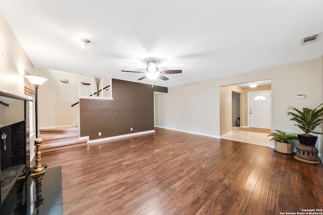 living room featuring wood-type flooring and ceiling fan