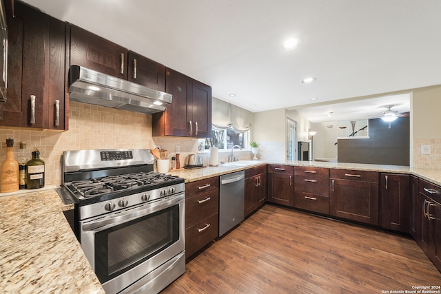 kitchen featuring backsplash, appliances with stainless steel finishes, ceiling fan, and dark hardwood / wood-style floors