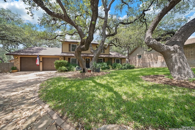 view of front of property featuring a garage and a front lawn