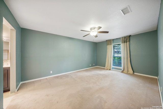 spare room with carpet flooring and ceiling fan