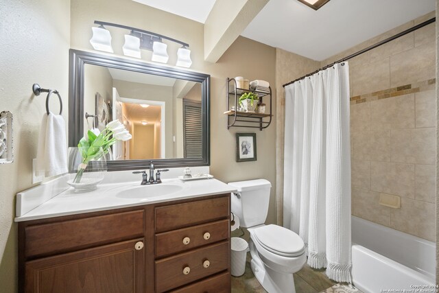 full bathroom with shower / bathtub combination with curtain, toilet, and vanity with extensive cabinet space