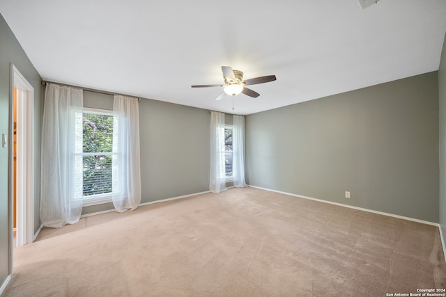 empty room with ceiling fan and light colored carpet