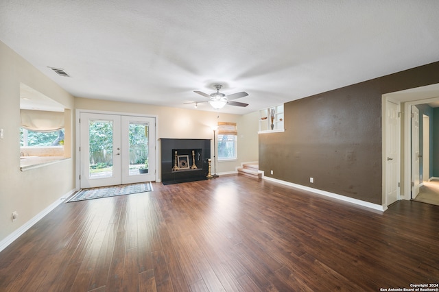 unfurnished living room featuring dark hardwood / wood-style floors, ceiling fan, and french doors