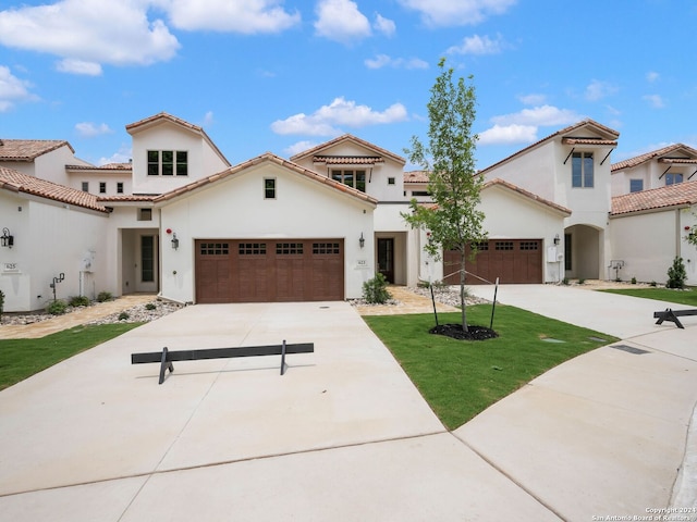 mediterranean / spanish house with a garage