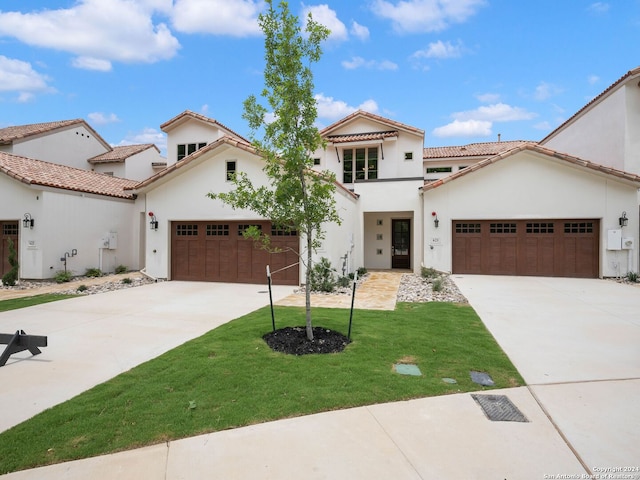 mediterranean / spanish-style house with a garage