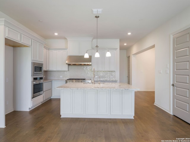 kitchen with dark wood-type flooring, stainless steel appliances, wall chimney exhaust hood, backsplash, and sink