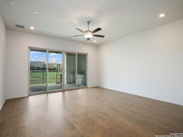 empty room with ceiling fan and wood-type flooring