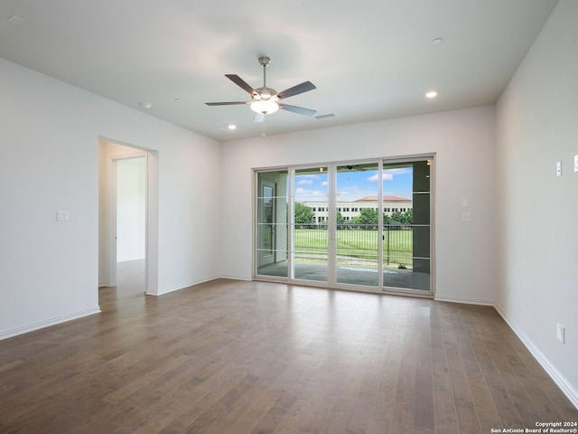 empty room with dark wood-type flooring and ceiling fan