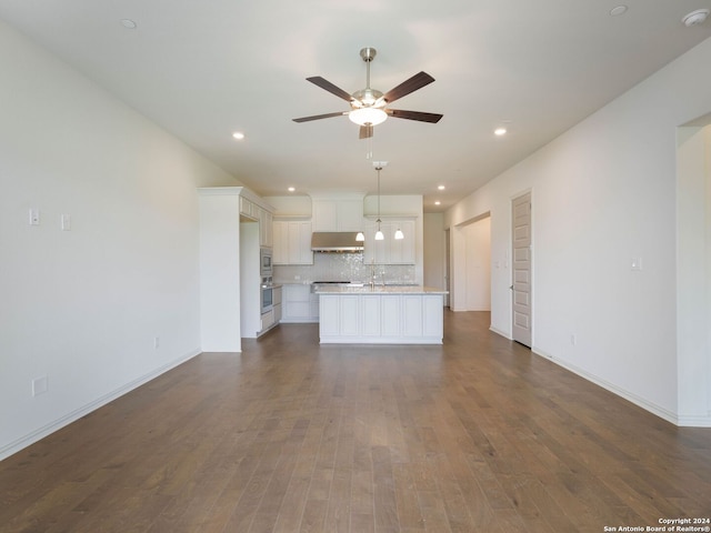 unfurnished living room with dark hardwood / wood-style floors and ceiling fan