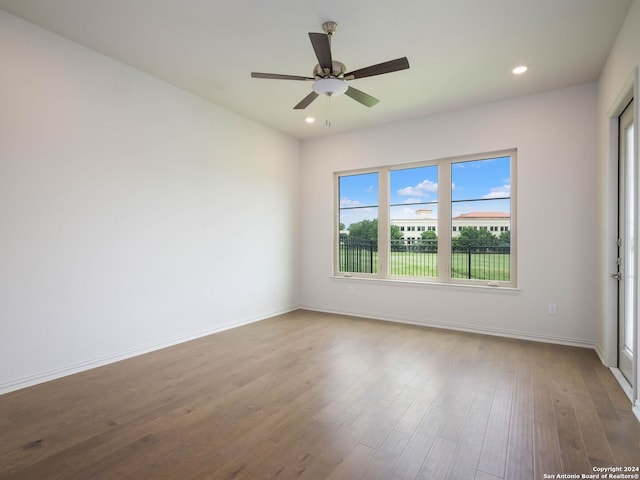 unfurnished room with wood-type flooring and ceiling fan