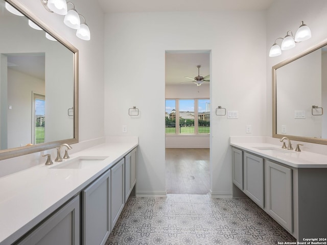 bathroom featuring double sink vanity, ceiling fan, and tile floors