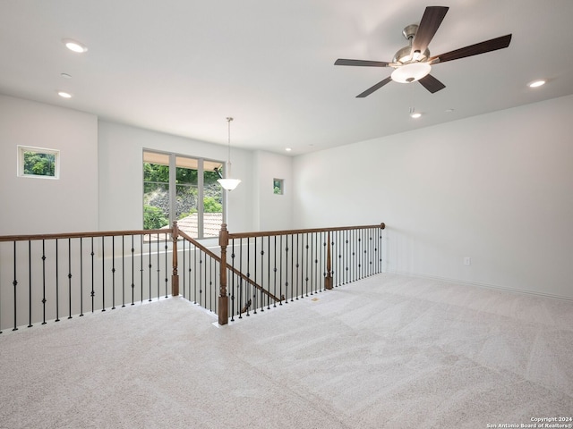 spare room featuring ceiling fan and carpet flooring