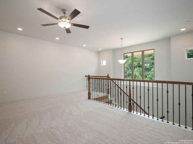 spare room featuring ceiling fan and carpet flooring