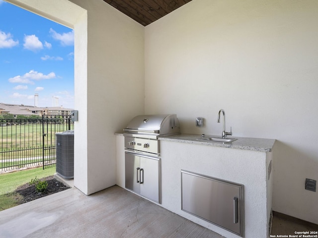 view of patio / terrace with sink, a grill, and central air condition unit