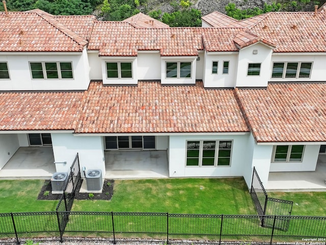 back of house featuring a yard, a patio area, and central air condition unit