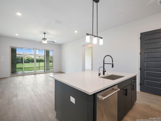 kitchen featuring ceiling fan, light hardwood / wood-style floors, a center island with sink, dishwasher, and sink