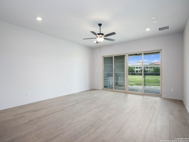 spare room featuring ceiling fan and light wood-type flooring