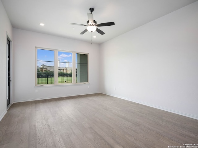 empty room with wood-type flooring and ceiling fan