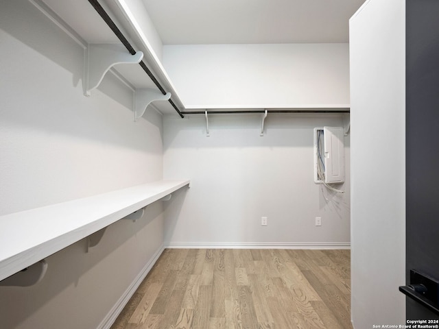 spacious closet with light hardwood / wood-style flooring