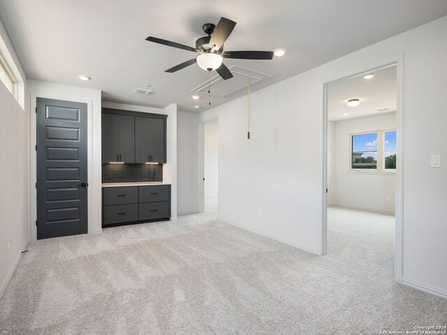 interior space with light carpet and ceiling fan