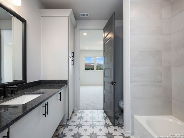 bathroom featuring tile flooring, toilet, and vanity