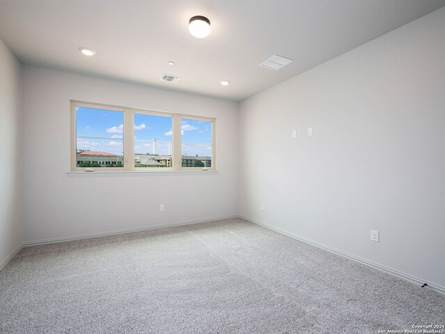 unfurnished room featuring carpet flooring