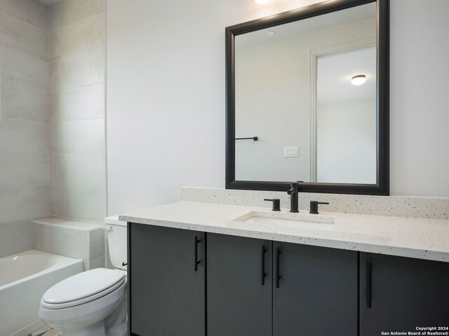 bathroom with vanity with extensive cabinet space and toilet