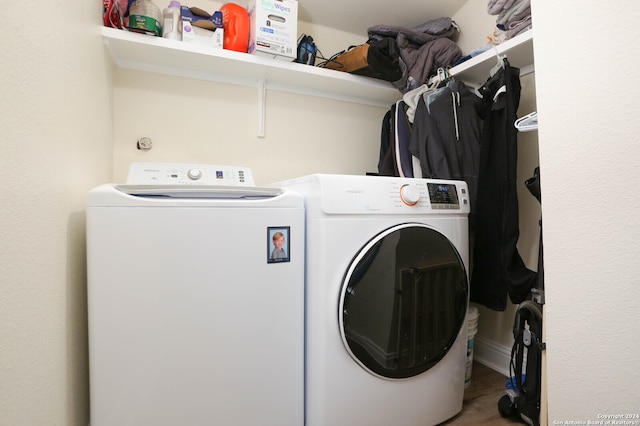 washroom featuring separate washer and dryer and wood-type flooring