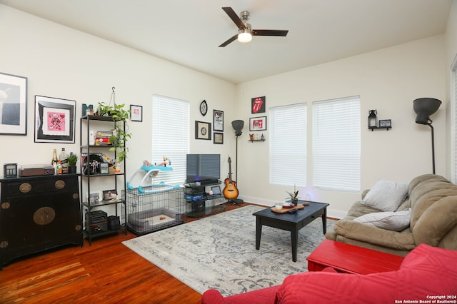 living room featuring dark hardwood / wood-style floors and ceiling fan