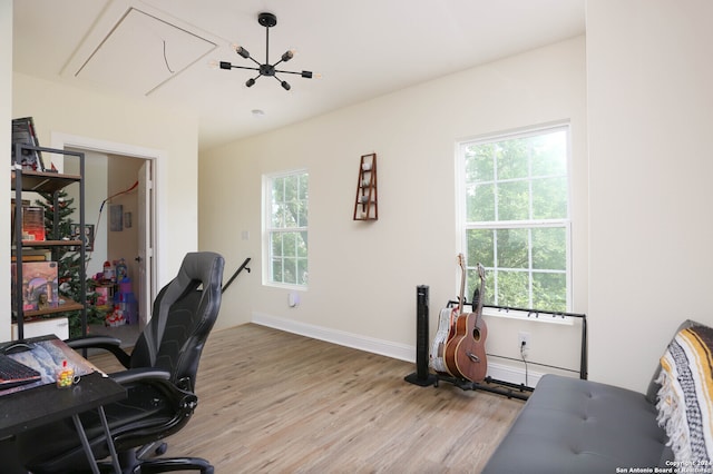 office featuring a notable chandelier and light hardwood / wood-style flooring