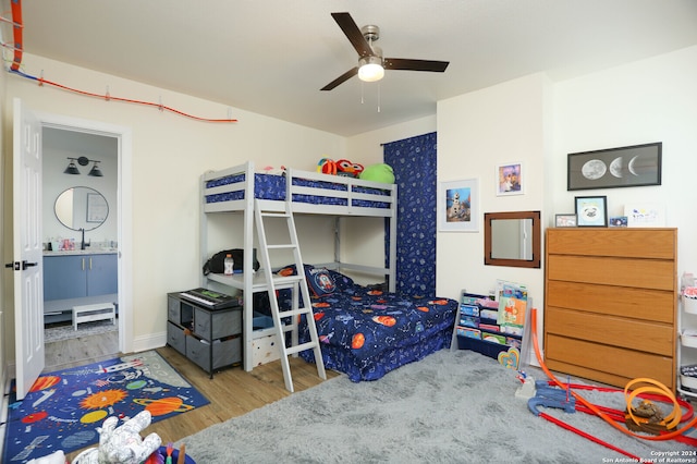 bedroom with ceiling fan, hardwood / wood-style floors, and sink