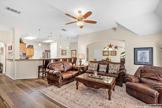 living room featuring ceiling fan and wood-type flooring