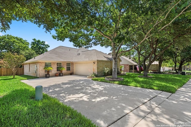 ranch-style home with a garage and a front lawn