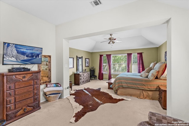 carpeted bedroom with ceiling fan and vaulted ceiling