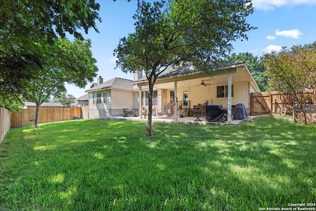 back of house with ceiling fan, a patio, and a yard