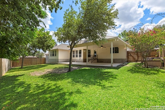 rear view of house with a lawn, ceiling fan, and a patio