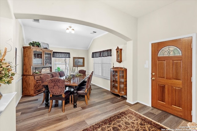 dining room featuring lofted ceiling and hardwood / wood-style floors