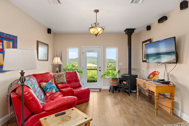 living room featuring hardwood / wood-style floors and a wood stove