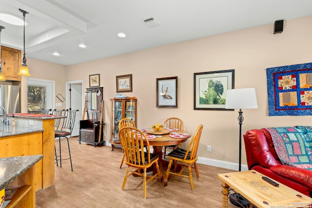 dining space with light wood-type flooring