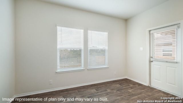 unfurnished room featuring dark hardwood / wood-style flooring and plenty of natural light