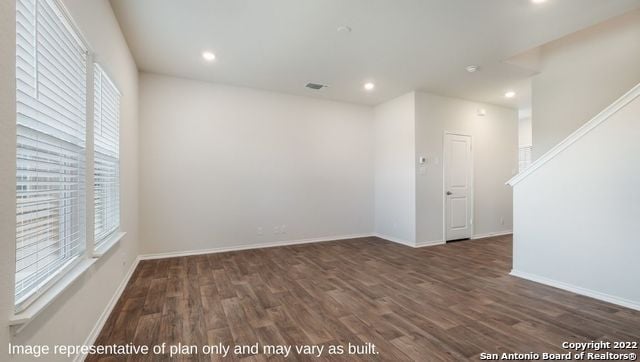 spare room with dark hardwood / wood-style flooring