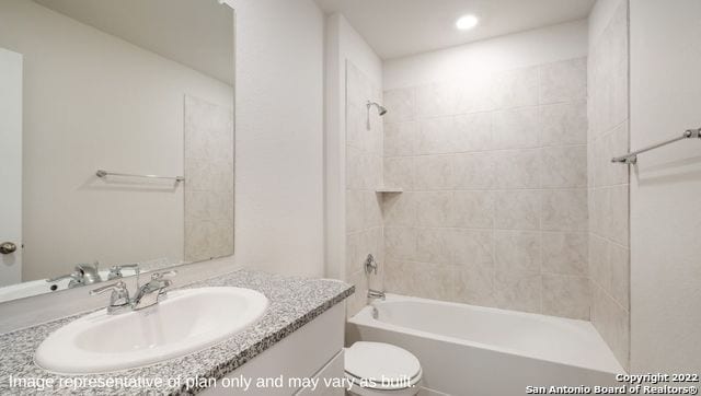 full bathroom with vanity, toilet, and tiled shower / bath