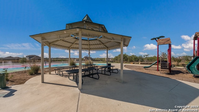 view of patio featuring a gazebo and a playground