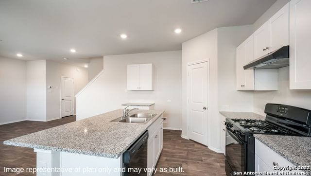 kitchen featuring black appliances, a center island with sink, sink, dark hardwood / wood-style floors, and white cabinetry