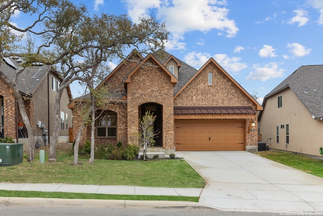 view of front of property with central AC and a front lawn