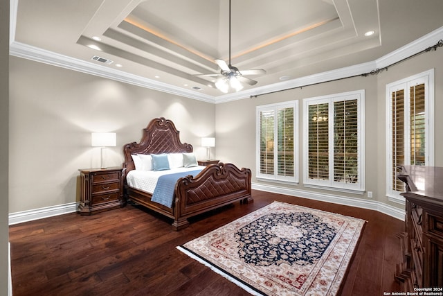 bedroom with a tray ceiling, ornamental molding, ceiling fan, and dark hardwood / wood-style flooring