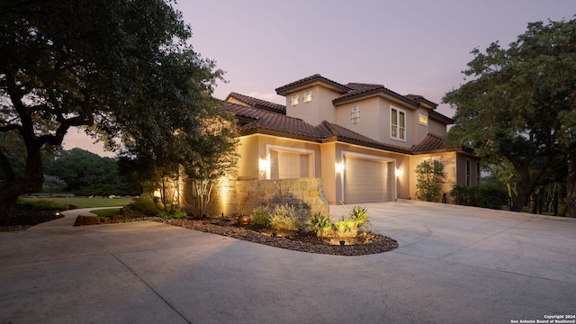 mediterranean / spanish-style house with a garage