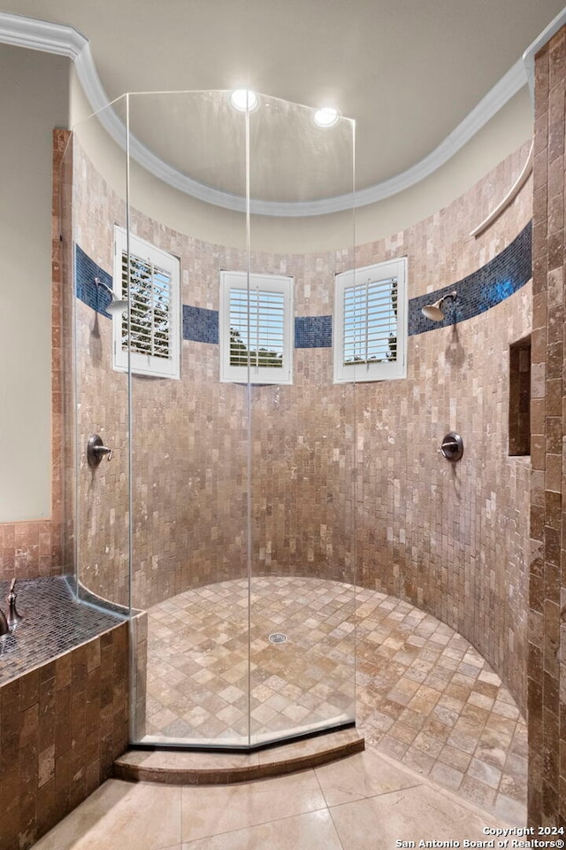 bathroom with tiled shower, crown molding, and tile flooring